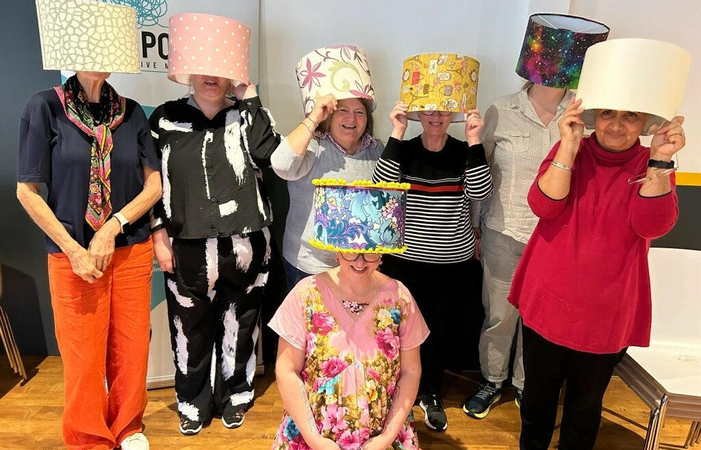 The winning photo - Participants show off lampshades made from upcycled and donated fabrics