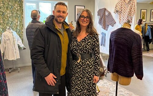 Theodore Panagiotidis, Sew Positive Trustee, with the charity's CEO Melissa Santiago Val at the exhibition